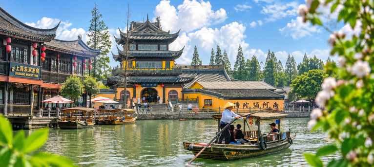Traditional waterside pavilion and sightseeing boats in Zhujiajiao Water Town, Shanghai