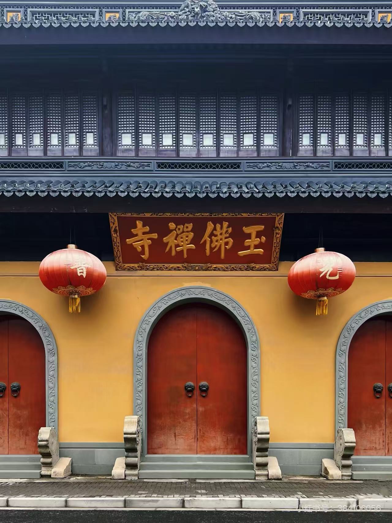 Jade Buddha Temple entrance in Shanghai with red doors, lanterns and traditional roof details